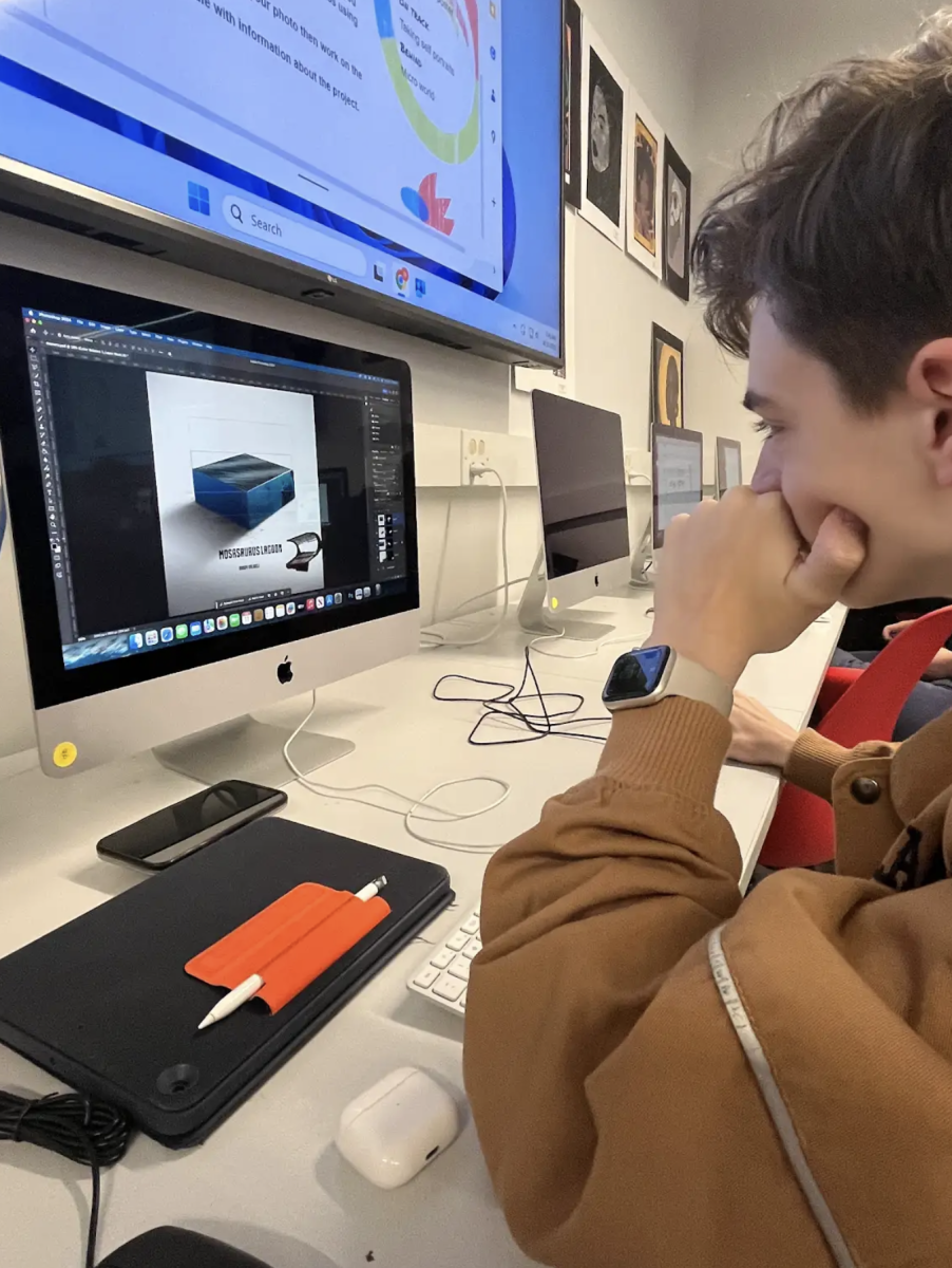 Sophomore Brody Colwell works on his visual communications micro-world project. The  goal of the project was to successfully create a world visualized in Photoshop in 3D illusion. Colwell chose to recreate a scene from the 'Jurassic Park' series, nicknamed 'Mosasaurus Lagoon'. "I like this project because it allows me to show my creativity, while also expressing my love for pop culture and movies." Colwell said.
